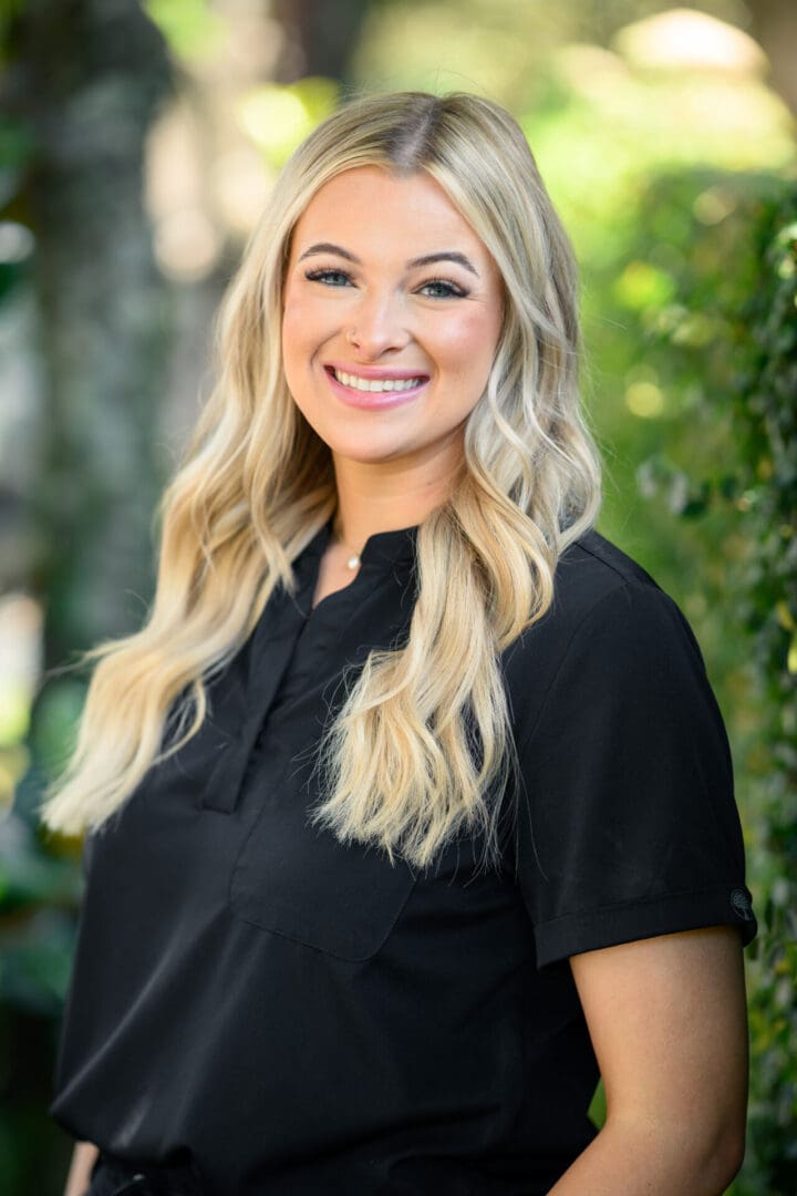 Smiling woman with long blonde hair.