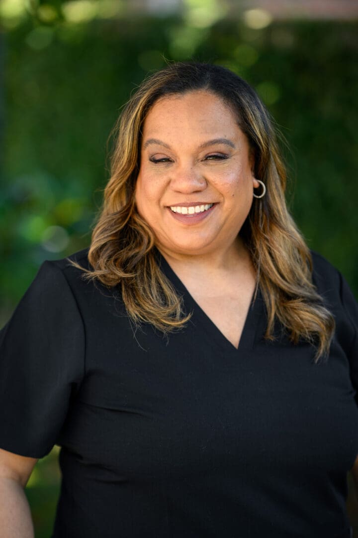 Smiling woman in a black shirt.